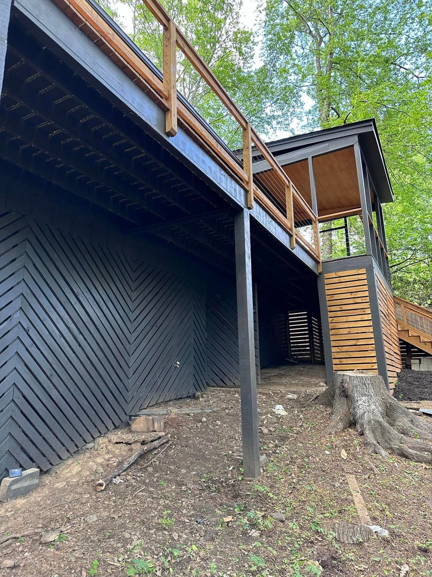 Elevated deck with herringbone privacy wall
