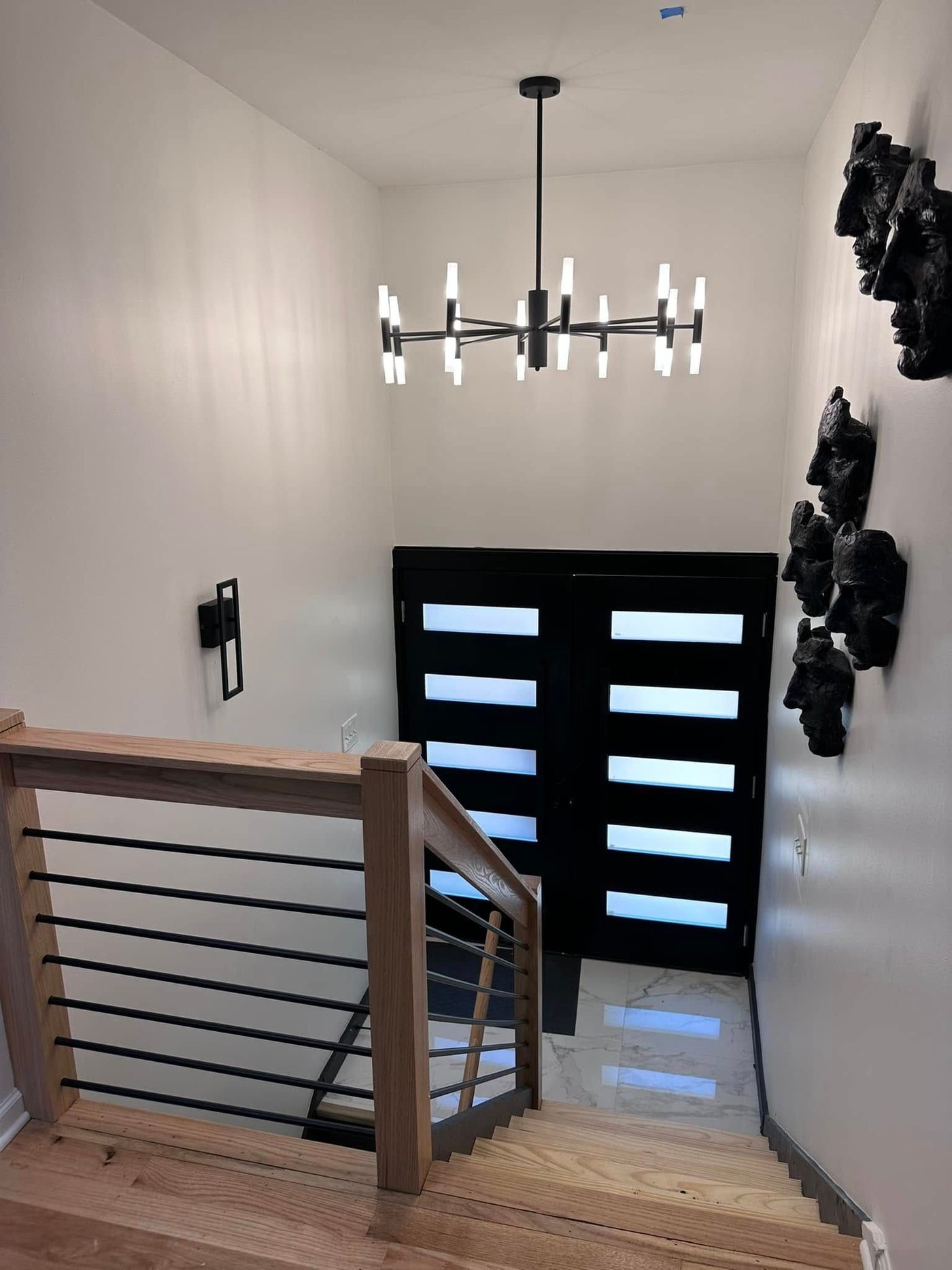 Entry staircase with modern chandelier