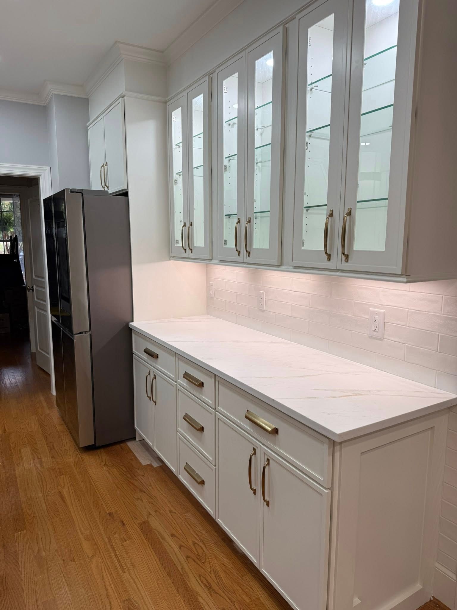 White kitchen with glass-front cabinets