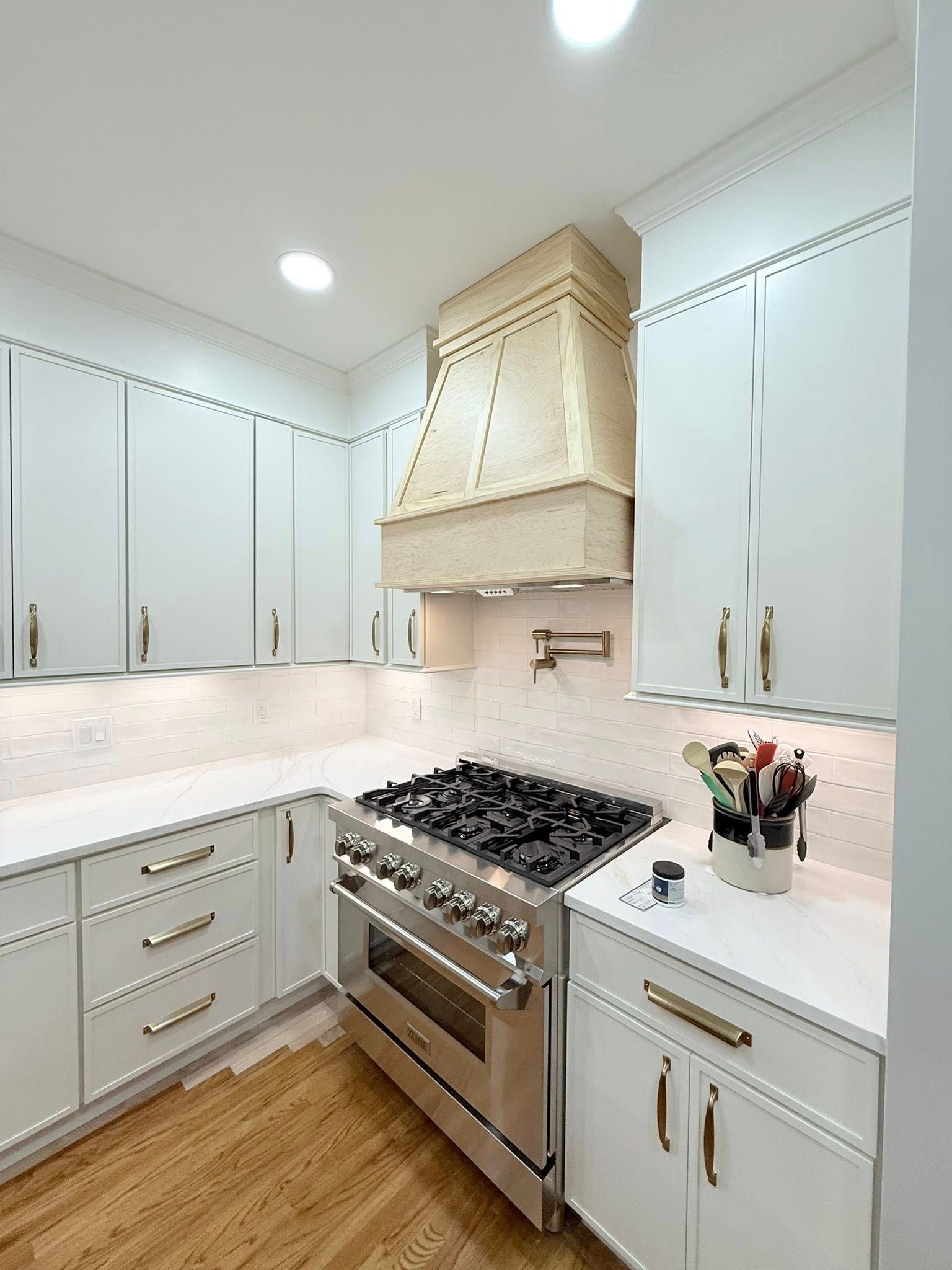 Custom range hood in white kitchen remodel