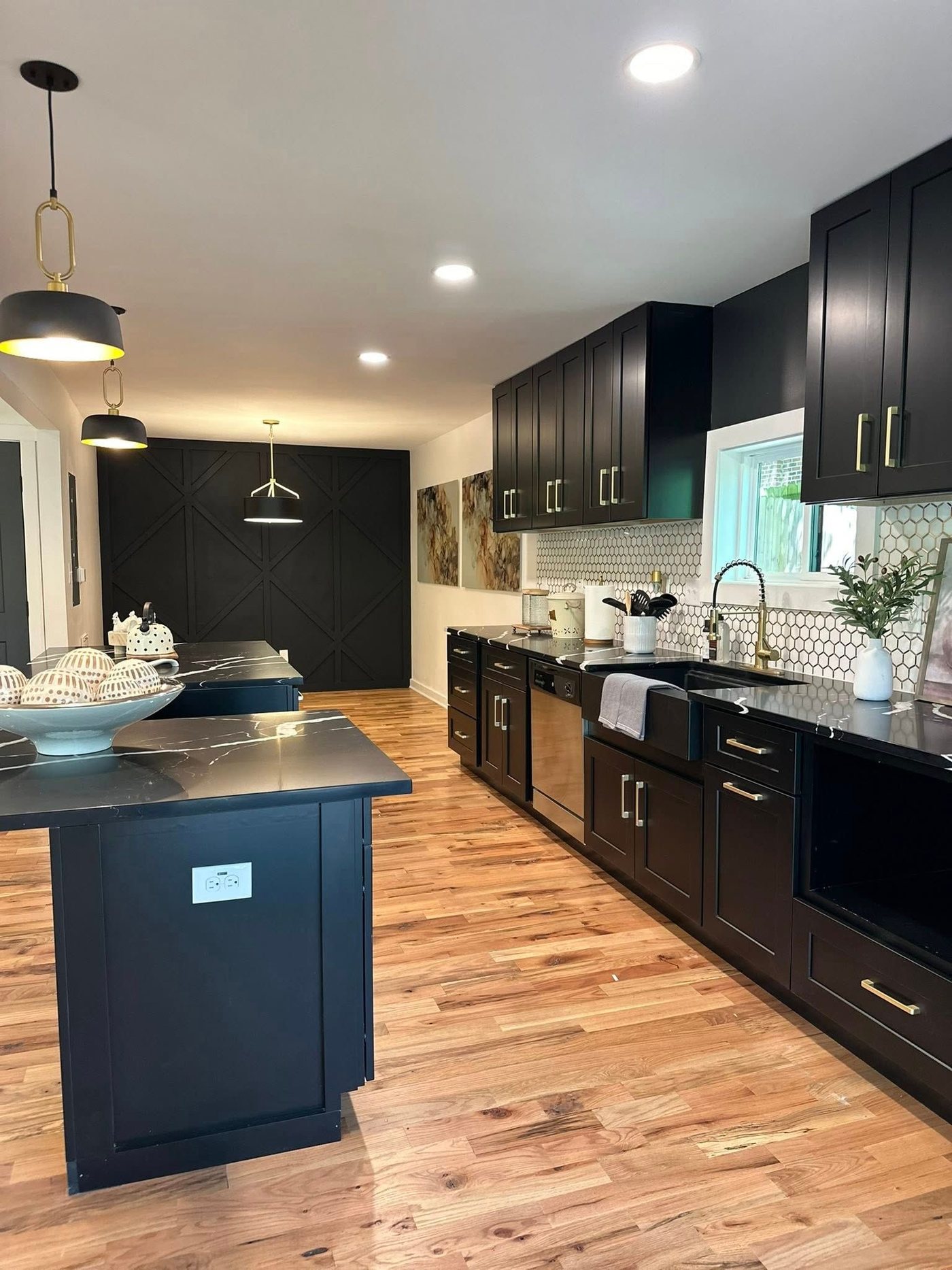 Two-tone kitchen with black cabinets and navy island