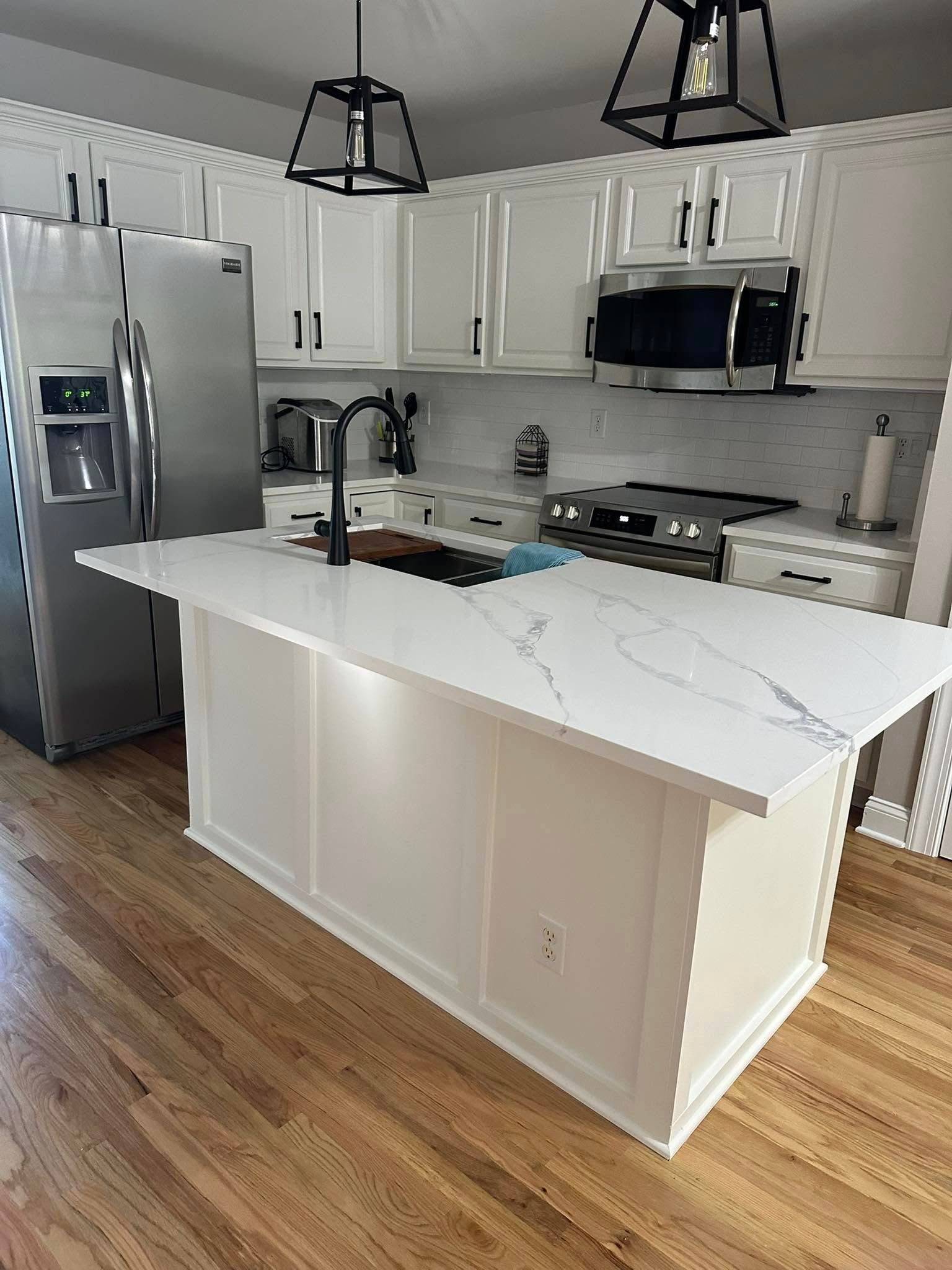White kitchen remodel with large island by Beast Mode Remodeling