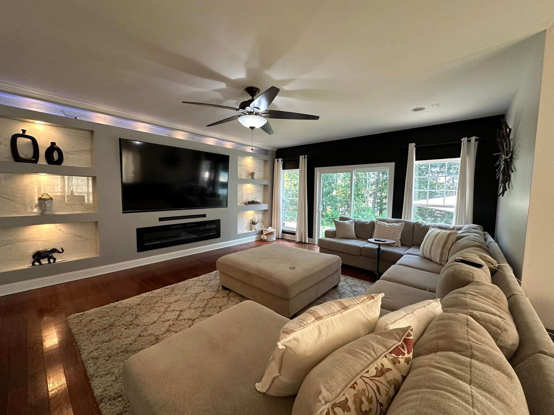 Finished living space with built-in media wall from a whole-home remodel